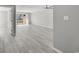 Bright and airy living room featuring light gray wood floors and sliding glass doors leading to a patio with a view at 306 74Th Ave. N # 105, Myrtle Beach, SC 29572