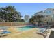 Inviting community pool area with lounge chairs, trees, and buildings in the background at 306 74Th Ave. N # 105, Myrtle Beach, SC 29572