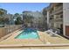 Community pool with lounge chairs and a view of the surrounding buildings at 306 74Th Ave. N # 105, Myrtle Beach, SC 29572