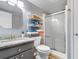 Bathroom featuring gray cabinets, granite counters, a walk-in shower, and a rack for towel storage at 3308 S Ocean Blvd. # 2-A, North Myrtle Beach, SC 29582