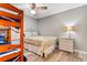 Bedroom with a bed, a bunk bed, a ceiling fan, wood-look flooring, and a nightstand with three drawers at 3308 S Ocean Blvd. # 2-A, North Myrtle Beach, SC 29582
