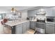 Open concept kitchen and dining area with stainless steel appliances and barstool seating at 3308 S Ocean Blvd. # 2-A, North Myrtle Beach, SC 29582