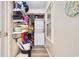 Stacked washer and dryer inside a hallway storage area with wire shelving at 3308 S Ocean Blvd. # 2-A, North Myrtle Beach, SC 29582