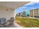 Cozy outdoor patio with seating and view of neighboring buildings and lawn at 3308 S Ocean Blvd. # 2-A, North Myrtle Beach, SC 29582