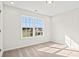 Bright, carpeted bedroom featuring a large window with a view of the neighborhood at 342 Barn Owl Way, Conway, SC 29527