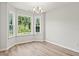 Bright dining room with large windows, natural light, and wood floors at 342 Barn Owl Way, Conway, SC 29527