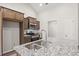 Modern kitchen features granite countertops, stainless steel appliances, and brown cabinets at 342 Barn Owl Way, Conway, SC 29527