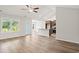Open-concept living room with hardwood floors, an island, and modern lighting at 342 Barn Owl Way, Conway, SC 29527