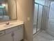 Bathroom featuring a vanity with sink and a glass-enclosed shower with tiled walls and seat at 360 Kapalua Loop, Little River, SC 29566