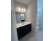 Stylish bathroom features a sleek vanity with quartz countertop, a large mirror, and tile flooring, creating a relaxing atmosphere at 360 Kapalua Loop, Little River, SC 29566