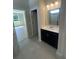 Well-lit bathroom showcases a modern vanity, quartz countertop, a large mirror, and tile flooring for a clean and stylish design at 360 Kapalua Loop, Little River, SC 29566