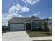 Charming single-story home featuring an attached garage, well-maintained lawn, and inviting curb appeal on a sunny day at 360 Kapalua Loop, Little River, SC 29566