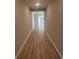 Long hallway features wood flooring with a view into the home's other living spaces creating a welcoming and functional design at 360 Kapalua Loop, Little River, SC 29566