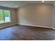 Spacious living room featuring hardwood floors, a large window, and ample natural light at 360 Kapalua Loop, Little River, SC 29566