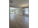 Spacious living room with natural light, beautiful floors and modern chandelier at 360 Kapalua Loop, Little River, SC 29566