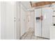 Hallway with white paneled closet, a refrigerator with an ice dispenser, and tile flooring at 400 20Th Ave. N # 1101, Myrtle Beach, SC 29577