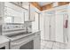 Bright kitchen with a window, stove, cabinetry, and a glimpse of the ocean view at 400 20Th Ave. N # 1101, Myrtle Beach, SC 29577
