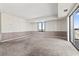 Spacious carpeted living room with a window and a sliding glass door to a balcony at 400 20Th Ave. N # 1101, Myrtle Beach, SC 29577
