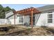 Cozy backyard patio area with pergola and table set for outdoor dining and relaxation at 413 Gouchos Ln., Myrtle Beach, SC 29588