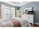 Bedroom featuring a comfortable bed, dresser with a mirror, and natural light from the window at 413 Gouchos Ln., Myrtle Beach, SC 29588