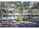 Multi-story condo building with white balconies, surrounded by trees and a parking lot at 415 Ocean Creek Blvd. # 2333, Myrtle Beach, SC 29572