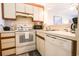 Well-maintained kitchen featuring white appliances and a view into the living area at 415 Ocean Creek Blvd. # 2333, Myrtle Beach, SC 29572