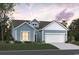 Charming single-Gathering home with blue siding, a two-car garage, and a well-manicured lawn at 416 Kapalua Loop, Little River, SC 29566
