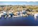 Stunning aerial view of waterfront commercial property with docks, boat slips, and a backdrop of lush trees at 4247 Villas Dr. # 406, Little River, SC 29566