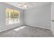 Bright bedroom with neutral walls, carpeted floors, ceiling fan, and large window at 4247 Villas Dr. # 406, Little River, SC 29566