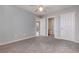 Neutral bedroom featuring plush gray carpet, ceiling fan, and views into adjacent rooms at 4247 Villas Dr. # 406, Little River, SC 29566