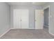 Bedroom featuring gray walls, closet, carpeted floors, and natural light at 4247 Villas Dr. # 406, Little River, SC 29566