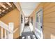 Well-lit hallway with exterior access features a covered porch and a unit entrance at 4247 Villas Dr. # 406, Little River, SC 29566