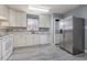 Bright kitchen featuring white appliances, wood-look floors, and ample countertop space at 4247 Villas Dr. # 406, Little River, SC 29566