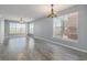 Spacious living room with ample natural light featuring gray walls and wood-look floors at 4247 Villas Dr. # 406, Little River, SC 29566