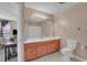 Neutral bathroom features a wood vanity with a bright mirror and tiled flooring at 4293 Parkway Ln. # 34, Little River, SC 29566