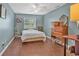 Cozy bedroom with a ceiling fan and vintage wooden dresser set against stylish blue painted walls at 4293 Parkway Ln. # 34, Little River, SC 29566