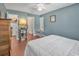 Comfortable bedroom with hardwood floors and an open doorway leading to the closet and Primary bath at 4293 Parkway Ln. # 34, Little River, SC 29566