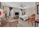Inviting bedroom with ceiling fan and large windows, cozy seating arrangement and TV stand at 4293 Parkway Ln. # 34, Little River, SC 29566