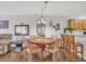 Dining area with a wooden table and seating for four is adjacent to the eat-in kitchen at 4293 Parkway Ln. # 34, Little River, SC 29566