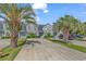 Charming exterior view of townhomes with palm trees and blue shutters at 4293 Parkway Ln. # 34, Little River, SC 29566