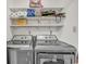 Functional laundry room featuring modern washer and dryer, with shelving for storage of supplies at 4293 Parkway Ln. # 34, Little River, SC 29566