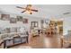 Comfortable living room featuring a large sofa, ceiling fan, wood floors and a view of the eat-in kitchen at 4293 Parkway Ln. # 34, Little River, SC 29566