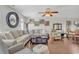 Inviting living room featuring a large sofa, ceiling fan, wood floors and plentiful natural light at 4293 Parkway Ln. # 34, Little River, SC 29566