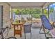 View of the screened porch with table and chairs at 4293 Parkway Ln. # 34, Little River, SC 29566