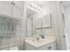 Well-lit bathroom with white vanity, medicine cabinet, and a neutral plaid wallpaper at 4405 Eastport Blvd. # D-8, Little River, SC 29566