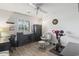 Bright bedroom with a desk and a fitness bike, featuring a large window and neutral walls at 4405 Eastport Blvd. # D-8, Little River, SC 29566