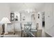 Cozy dining area with a white round table, seating for four, and an arched entrance to the kitchen at 4405 Eastport Blvd. # D-8, Little River, SC 29566