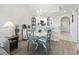 Cozy dining area with chandelier, table with four chairs, and view into the kitchen at 4405 Eastport Blvd. # D-8, Little River, SC 29566