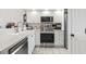Well lit kitchen featuring stainless steel appliances, white cabinets, and a tiled floor at 4405 Eastport Blvd. # D-8, Little River, SC 29566