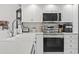 Modern kitchen showcasing stainless steel appliances, white cabinetry, and sleek countertops at 4405 Eastport Blvd. # D-8, Little River, SC 29566
